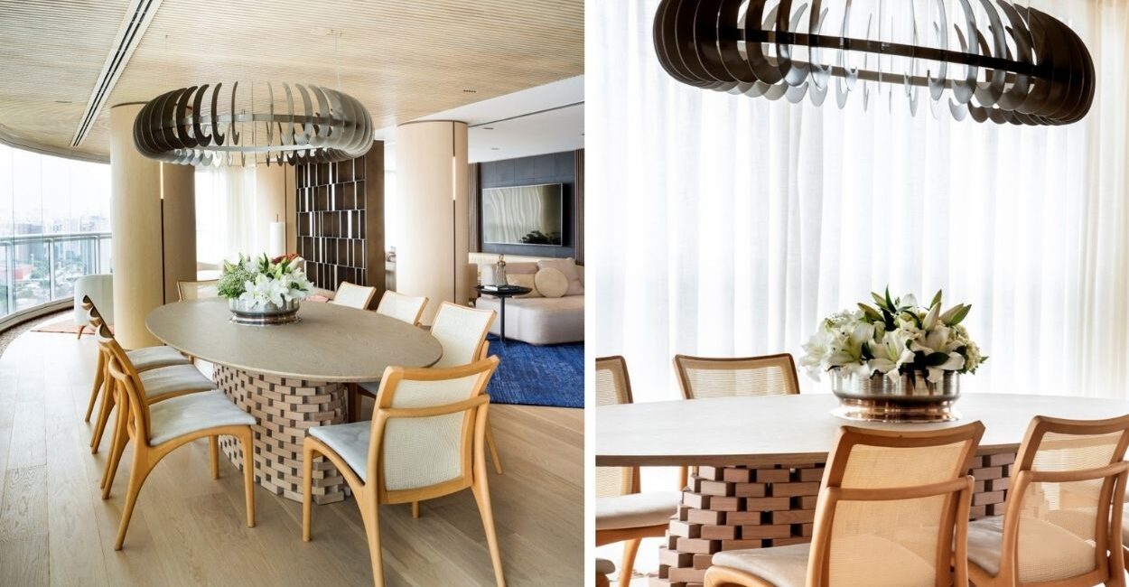 A planta circular deste projeto assinado pela  arquiteta e paisagista Denise Barretto  orienta o uso de móveis orgânicos em todo o apartamento, incluindo a mesa oval da sala de jantar. Como centro da mesa, um vaso arredondado com lírios brancos reforça a linguagem fluida do projeto e estabelece continuidade com as curvas presentes na arquitetura de interiores | Fotos: Rômulo Fialdini